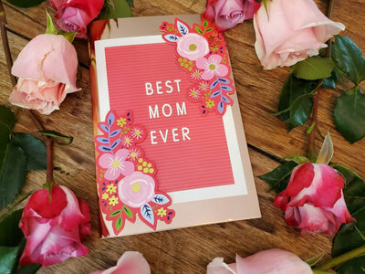 A "Best Mom Ever" card with roses surrounding it