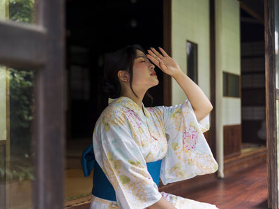 A Woman in a Yukata Wipes Sweat from her Face