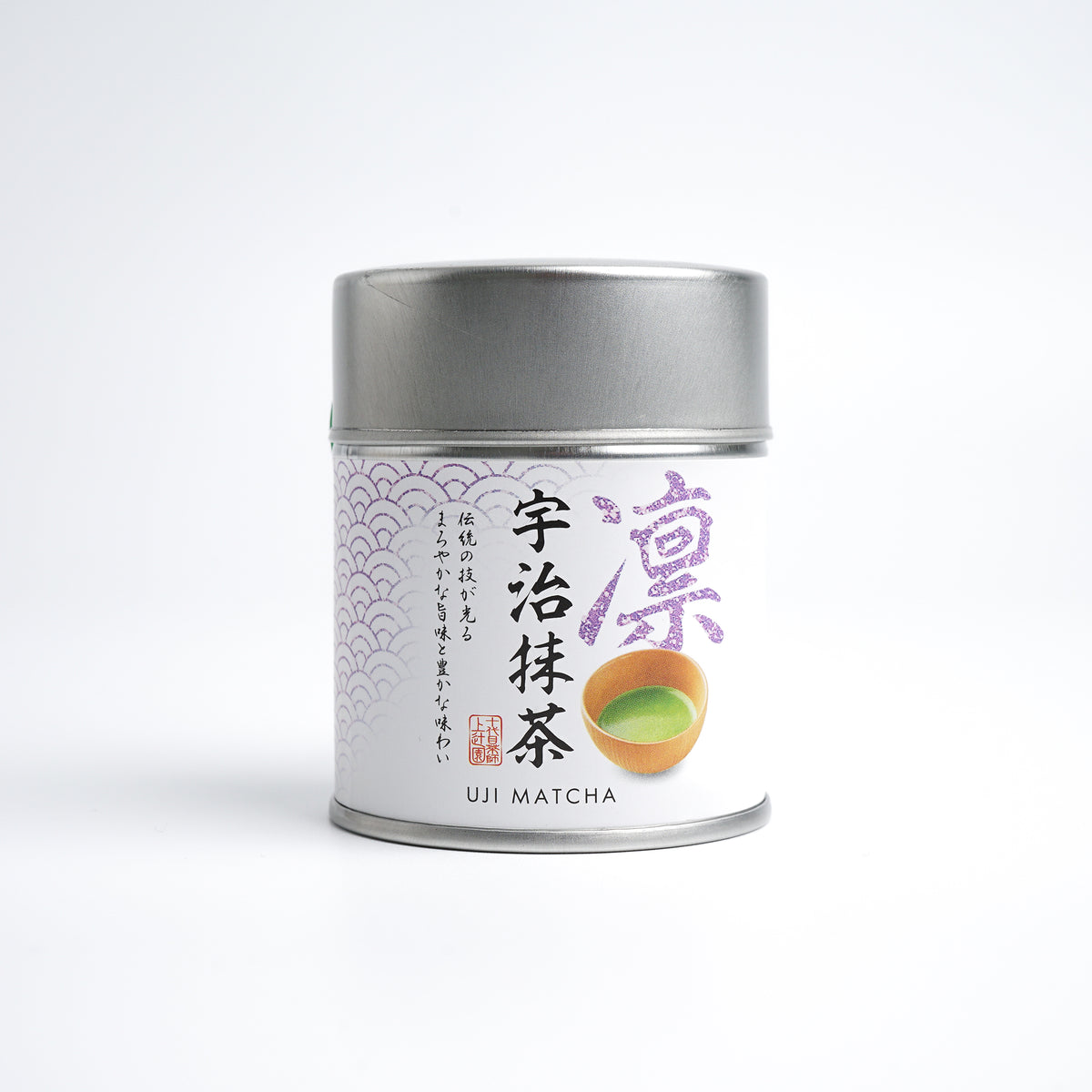 A tin can of Kamitsujien Uji Matcha green tea powder with Japanese text and a picture of a tea leaf on the label.
