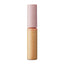 A tube of WHOMEE Concealer with the cap off, showing the product in a pinkish-orange shade appropriate for medium skin tone.